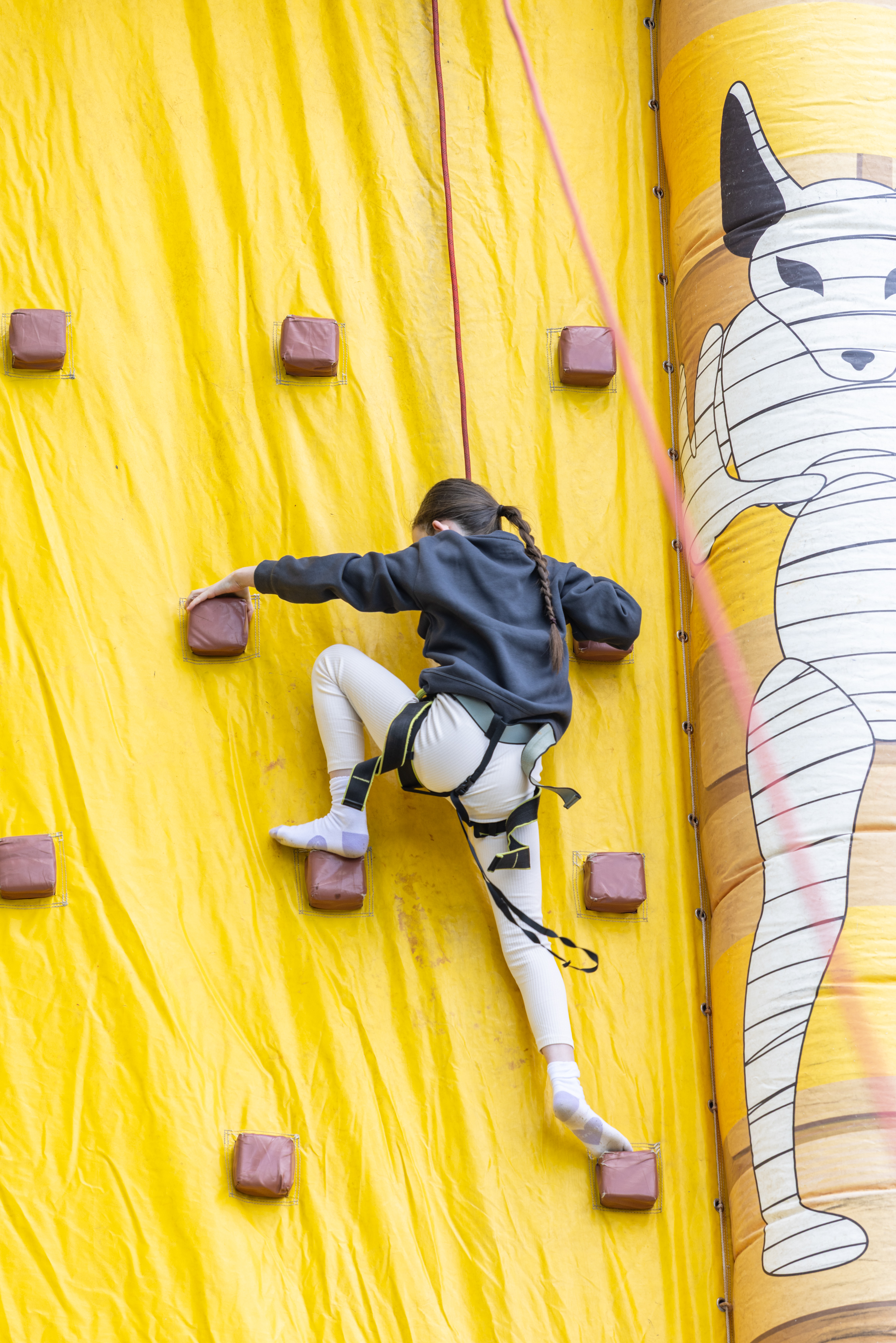 Person climbing bouncy castle.